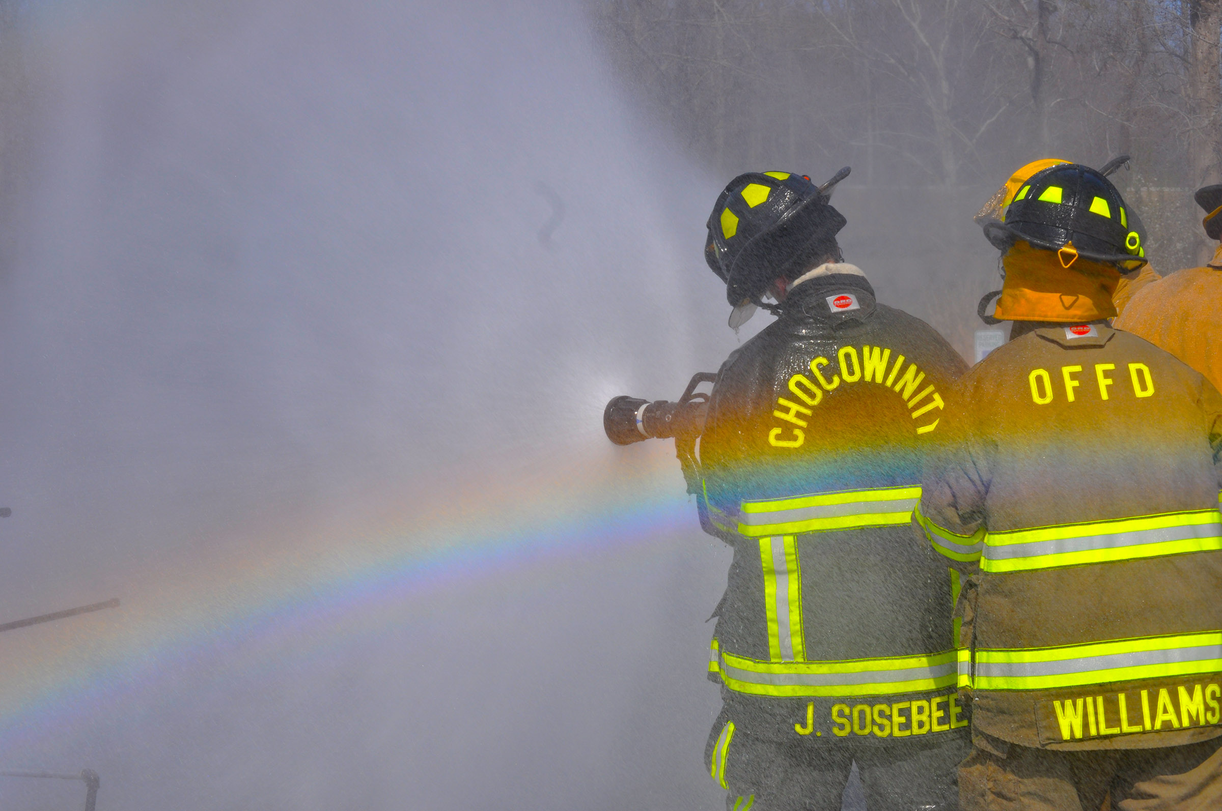 firefighters with a rainbow