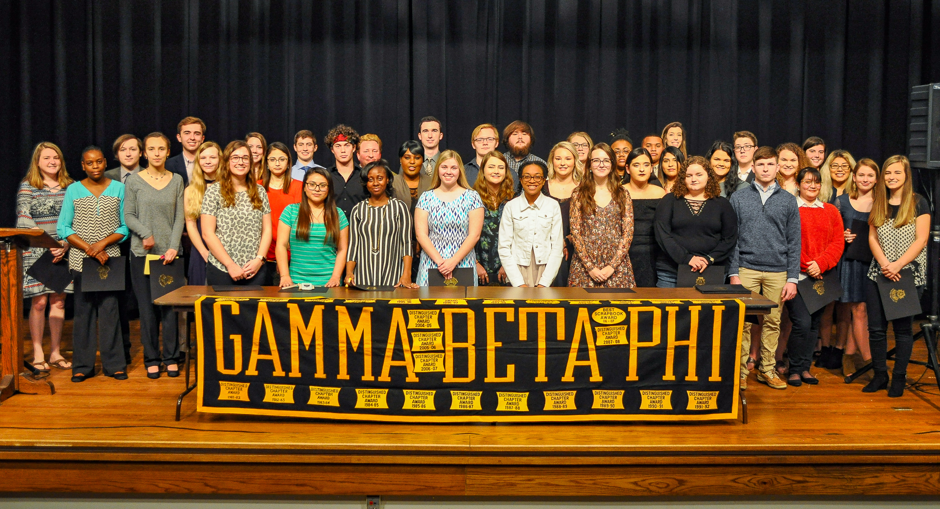 A large group behind a banner reading Gamma Beta Phi.