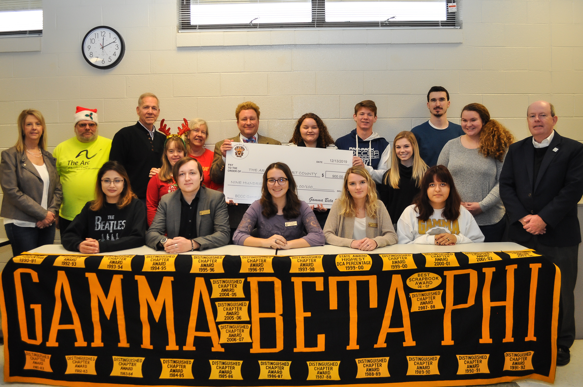 a group of people with a banner reading Gamma Beta Phi