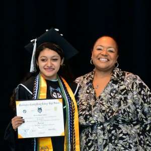 2 people smiling and holding a certificate.