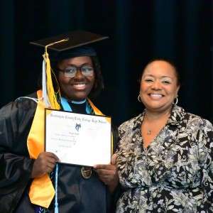 2 people smiling with diploma