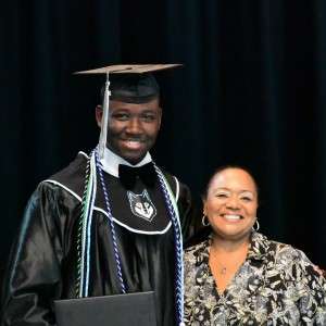 2 people with diplomas smiling