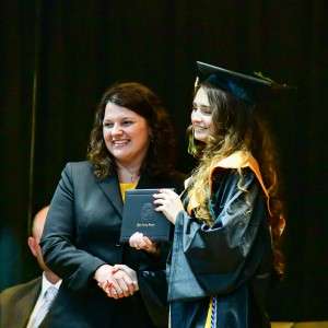 @ women on stage with a diploma
