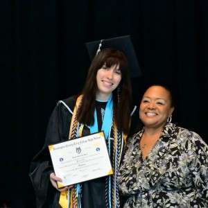2 women smiling holding a diploma