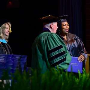 3 people on stage