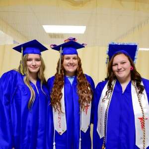 3 women in cap & gown
