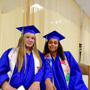 2 people in cap & gown.