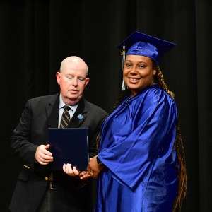 2 people on stage with a certificate