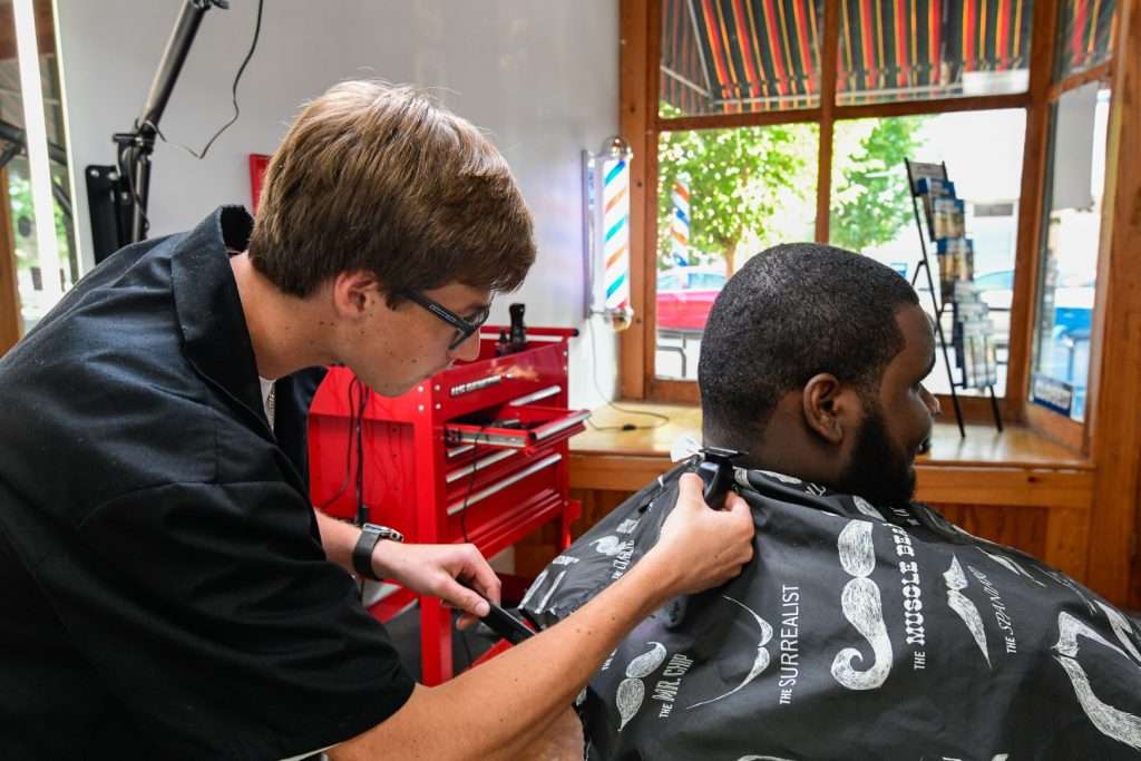 Man cutting anothers hair