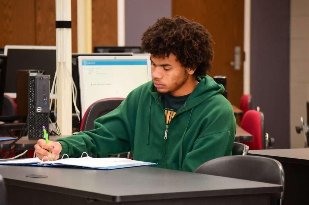 Person writing at desk