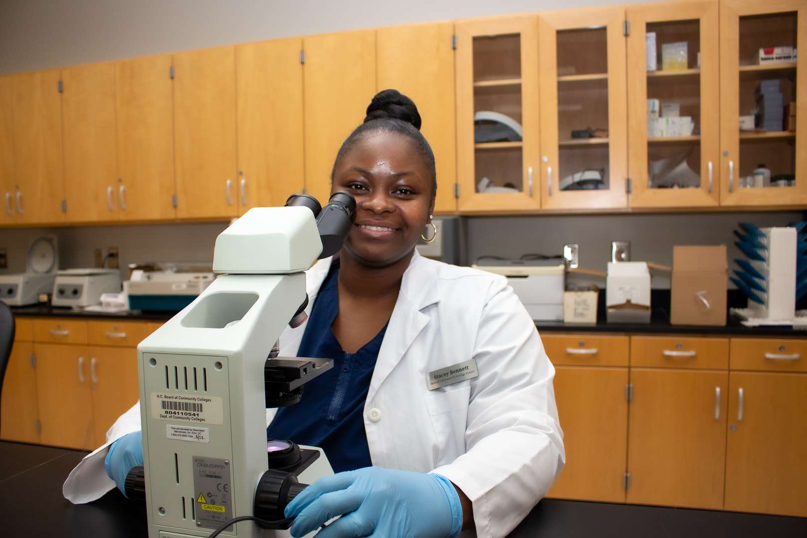 woman in front of a microscope