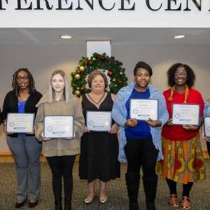 Group of people holding certificates