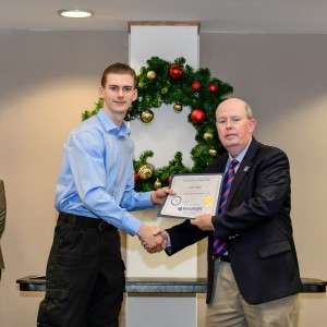 2 men on stage with certificate