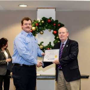 2 men holding a certificate
