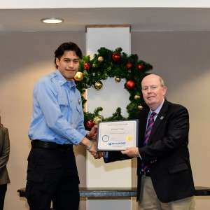 2 people on stage with certificate
