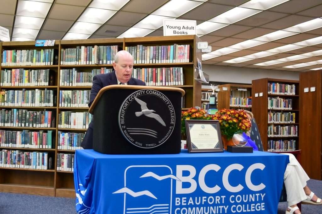 Man behind podium, speaking