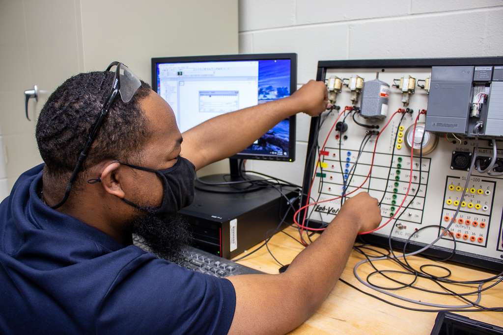 a person on a panel of wires