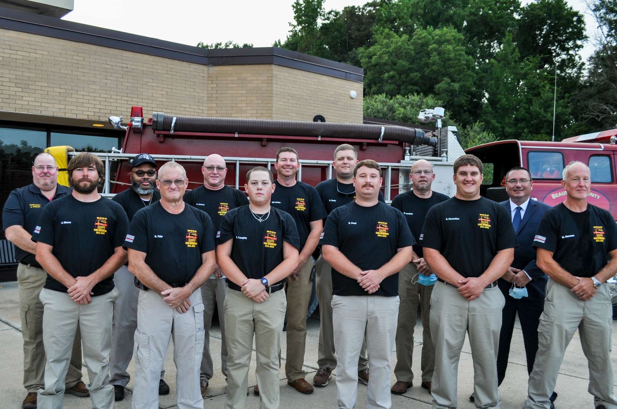 Group of men in front of a fire truck