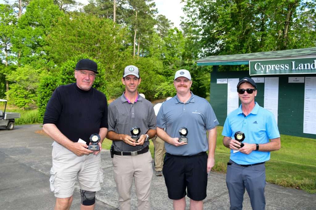 Men holding trophies