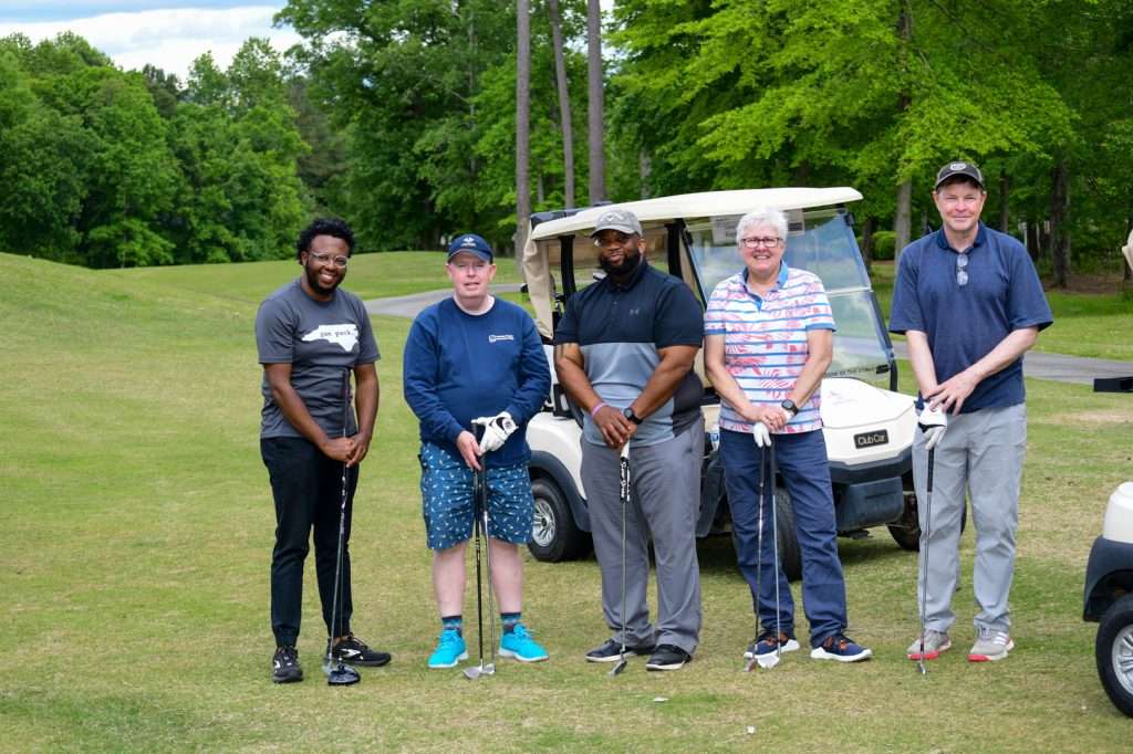 4 golfers on course