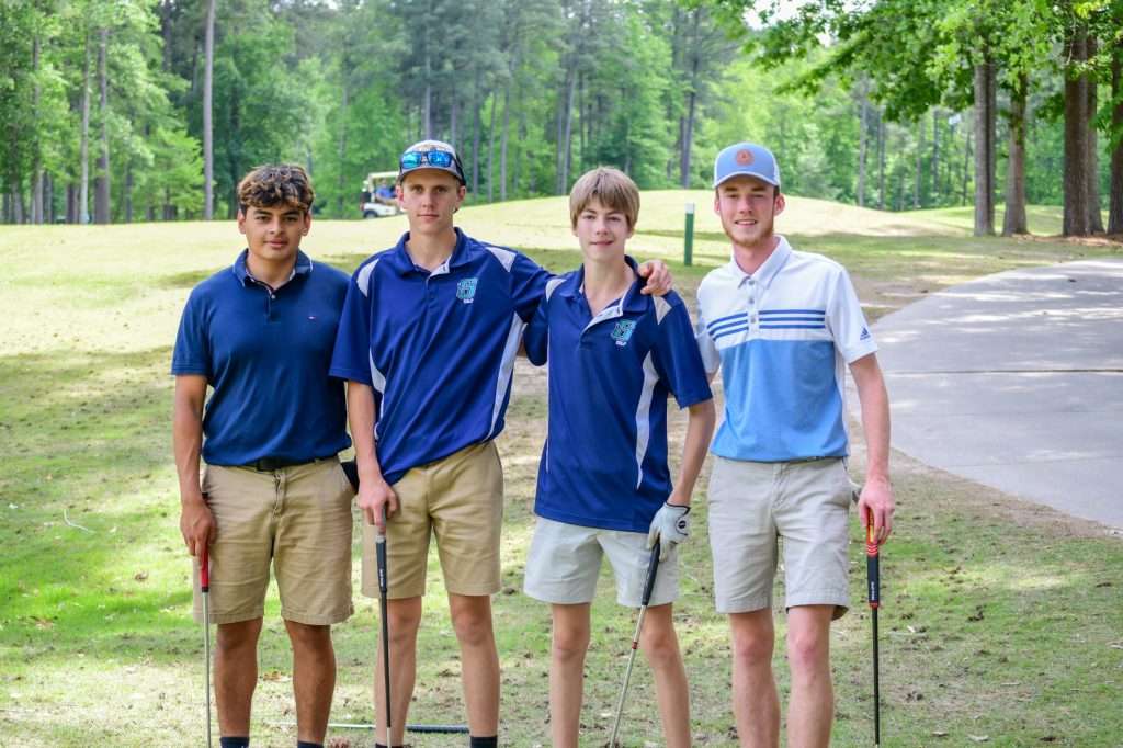 4 young person golf team