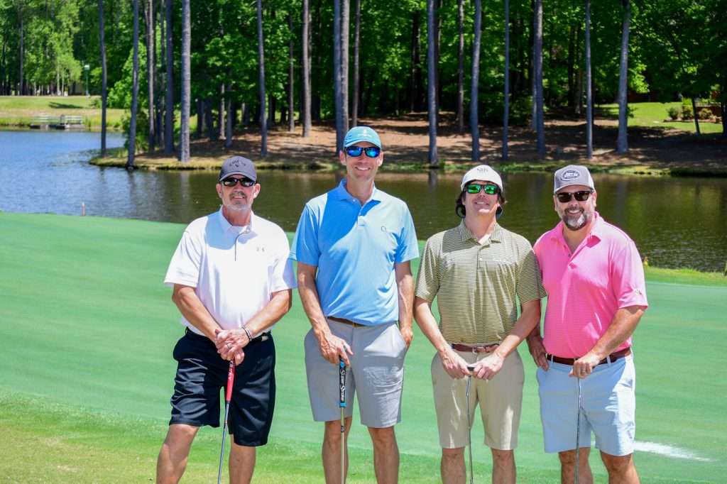 4 man team on golf course