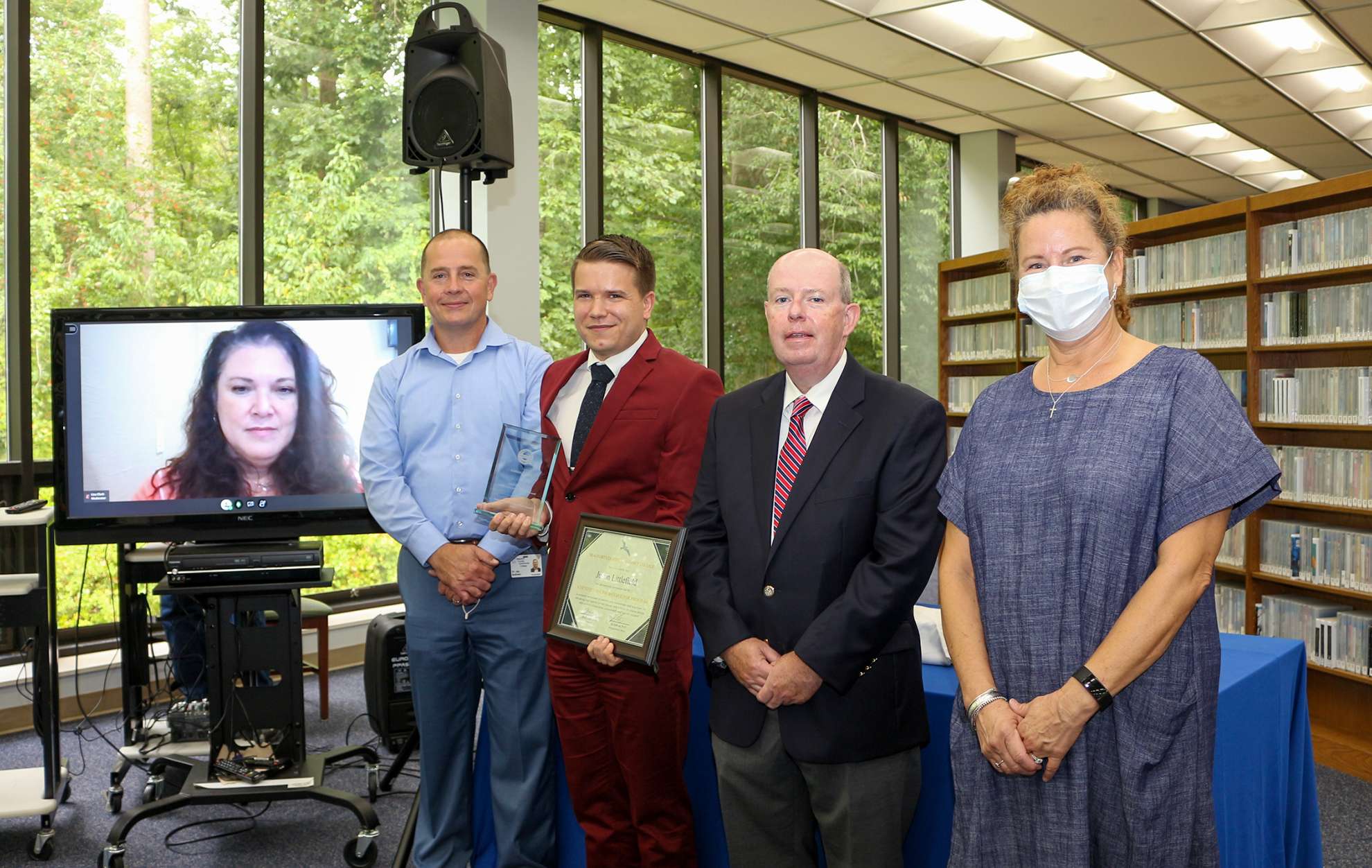 5 people, one on a screen