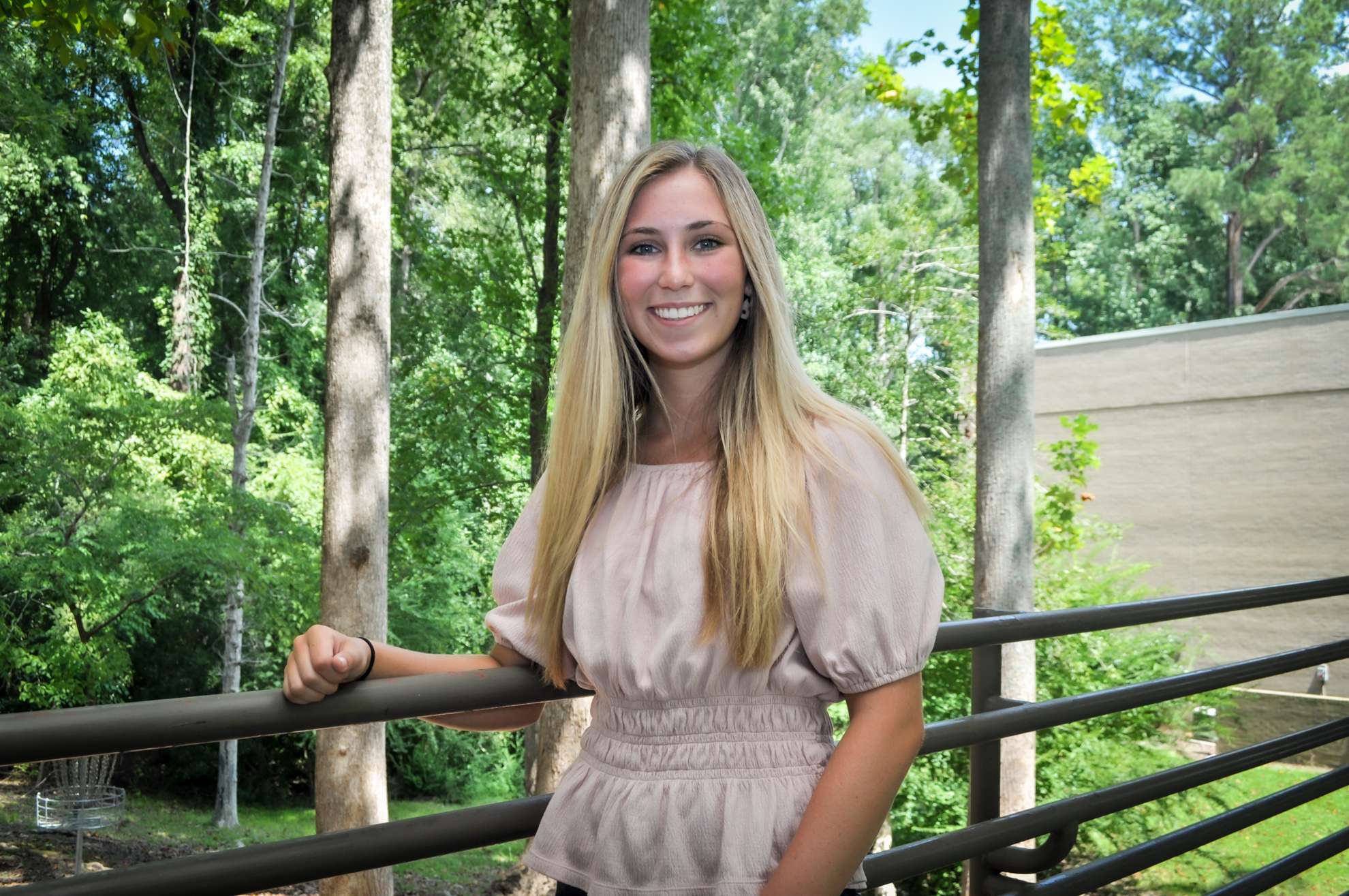 a person with woods behind her