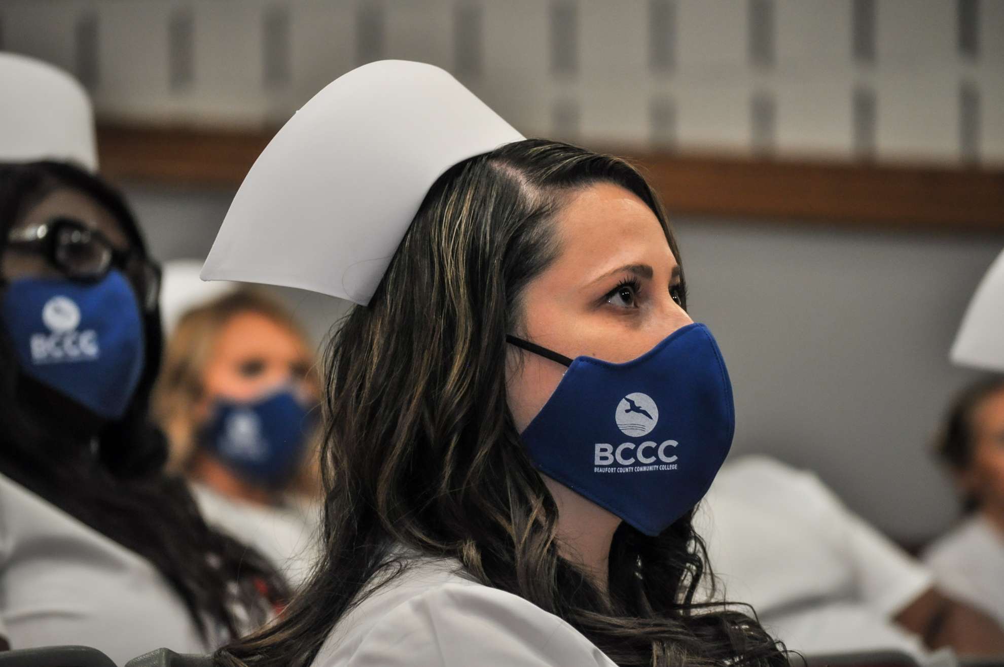 Woman in audience with a mask on