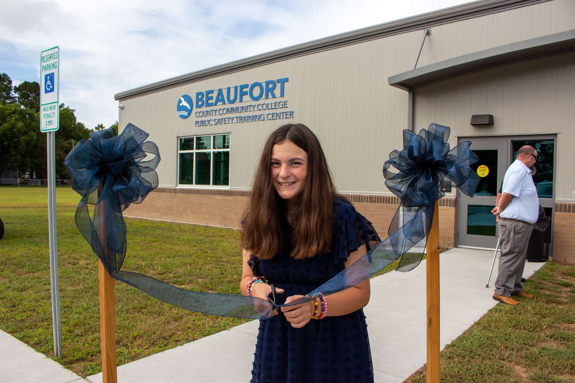 a person cutting a ribbon