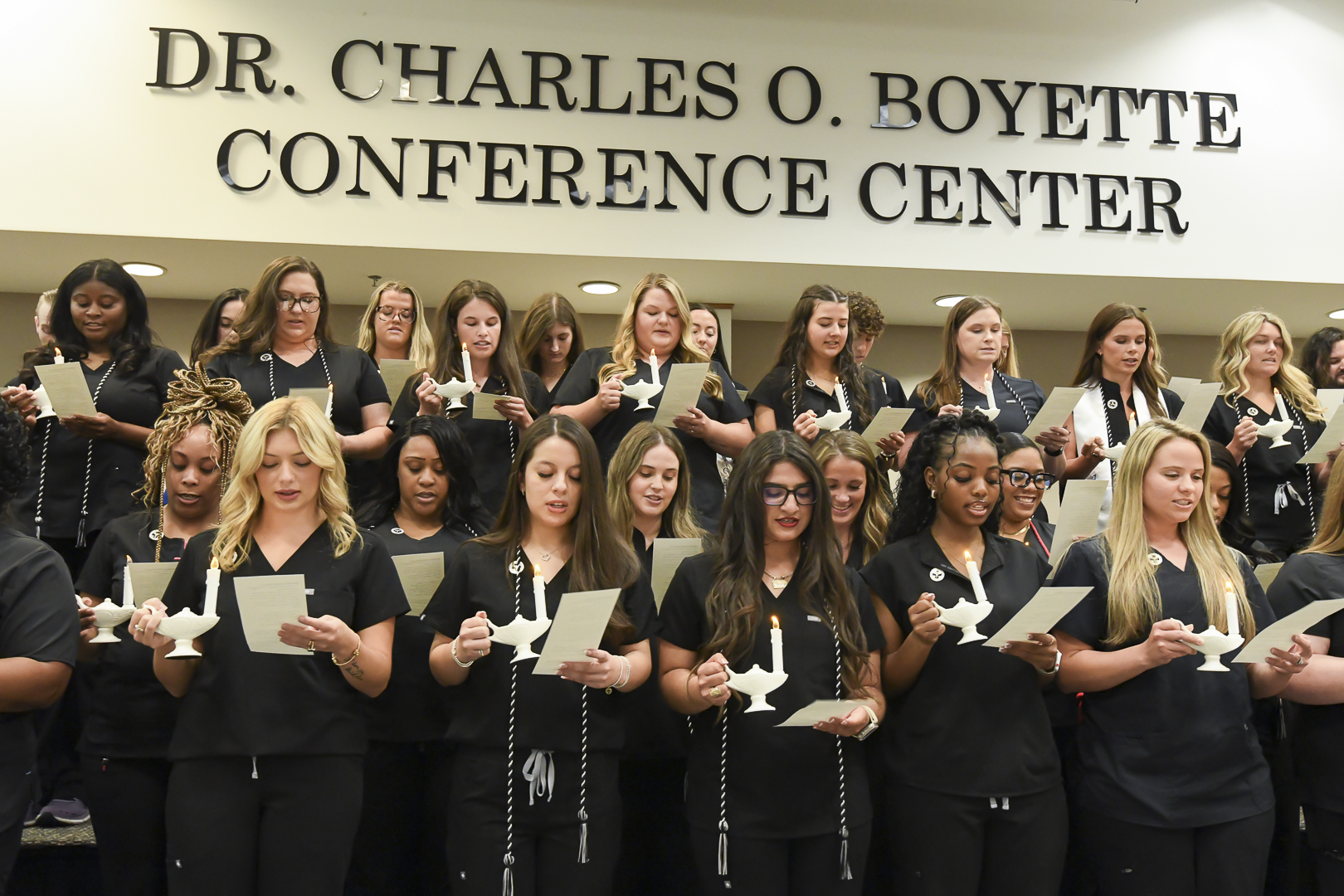 Large group of people in black with text Dr. Charles O Boyette Conference Center