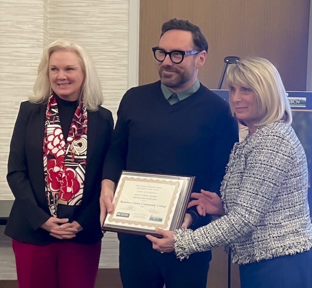three people and an award