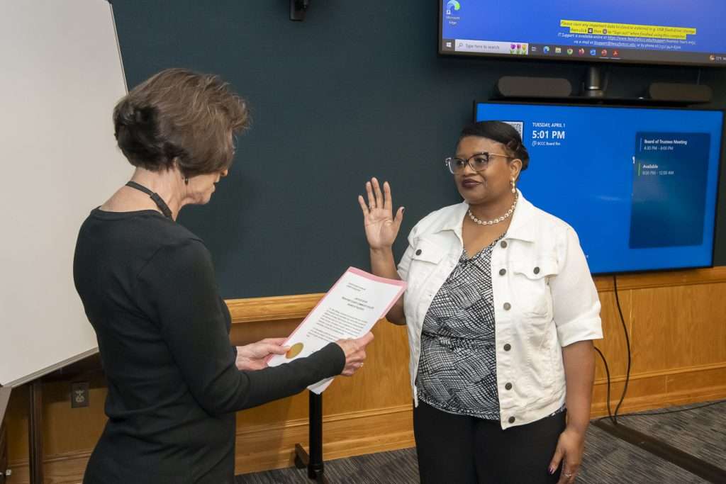 one person reading, another with hand up