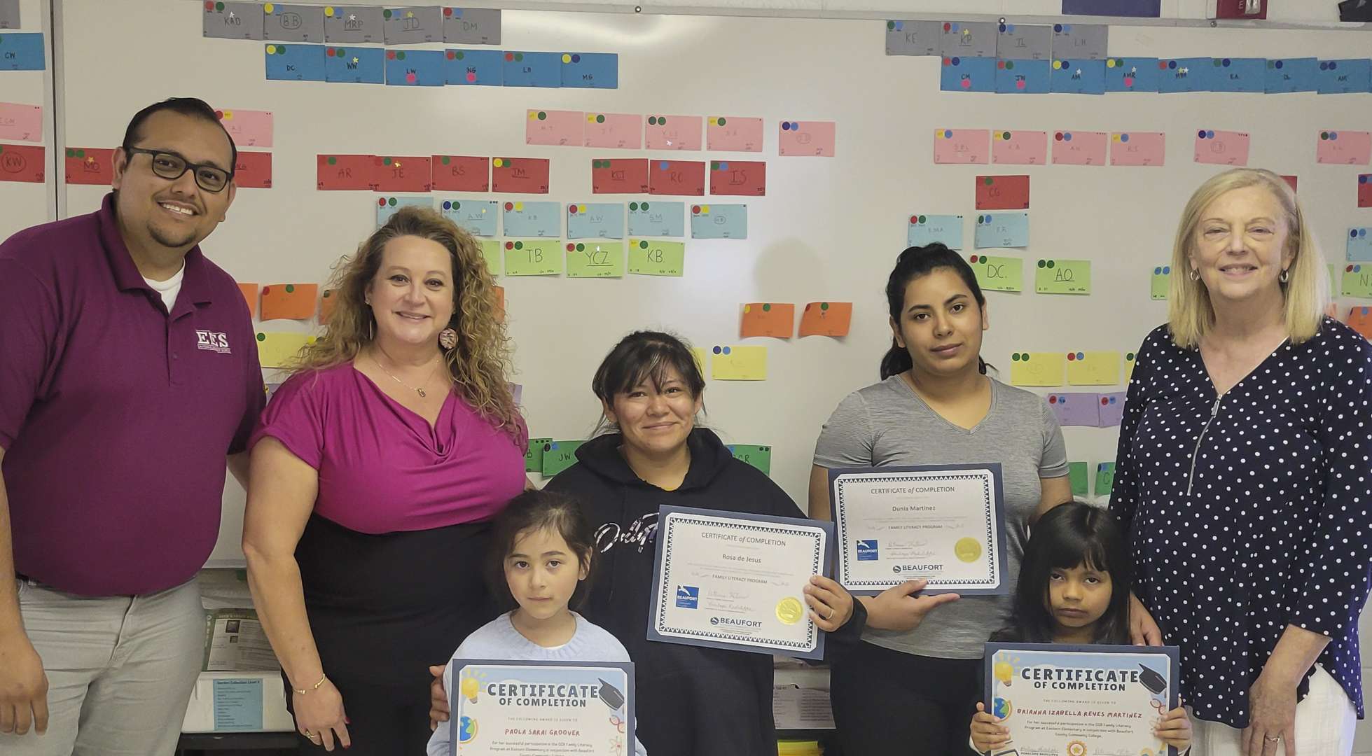 A family and others with certificates