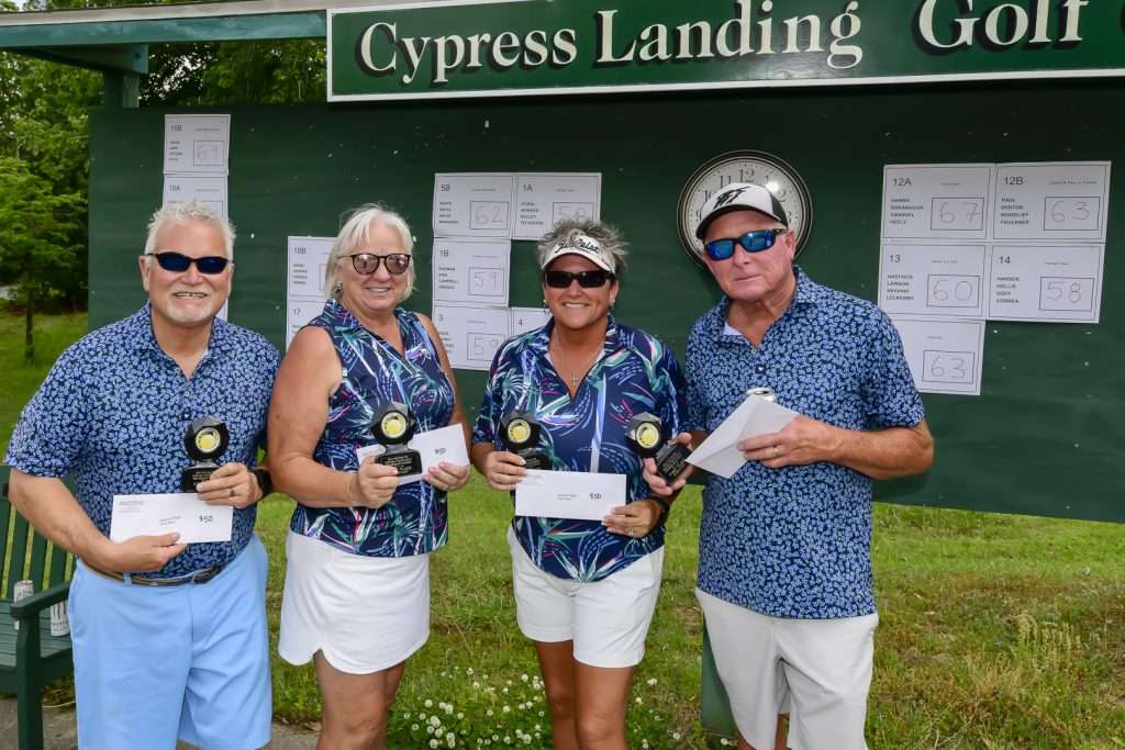 four people with checks