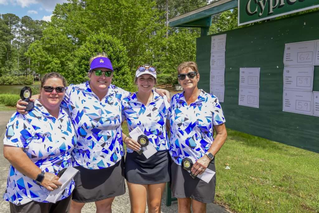 four people in a uniform shirt