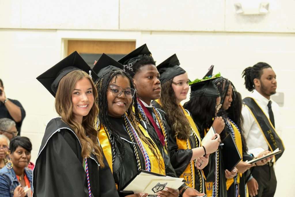 group of graduates in cap & gown