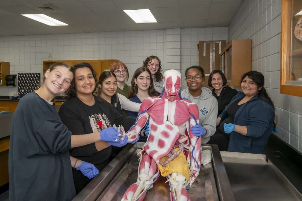 Students posing with anatomy model