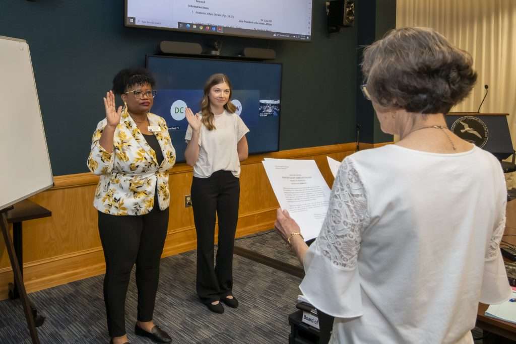 two people with hands raised