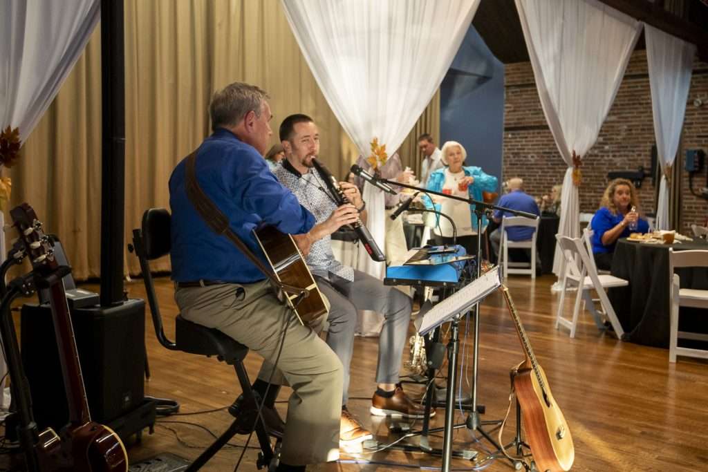 People on stage playing instrumants