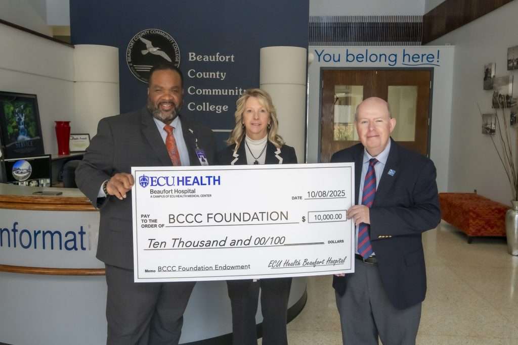 three people with a check
