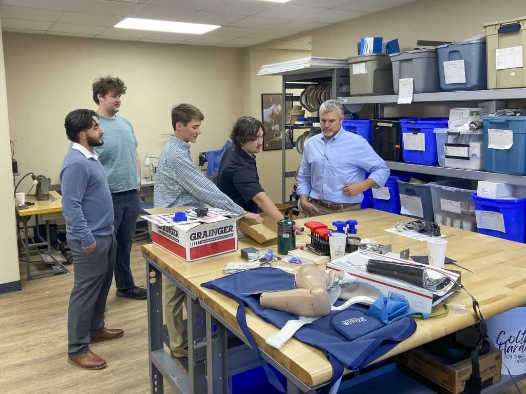 students with a table full prosthetics and tools