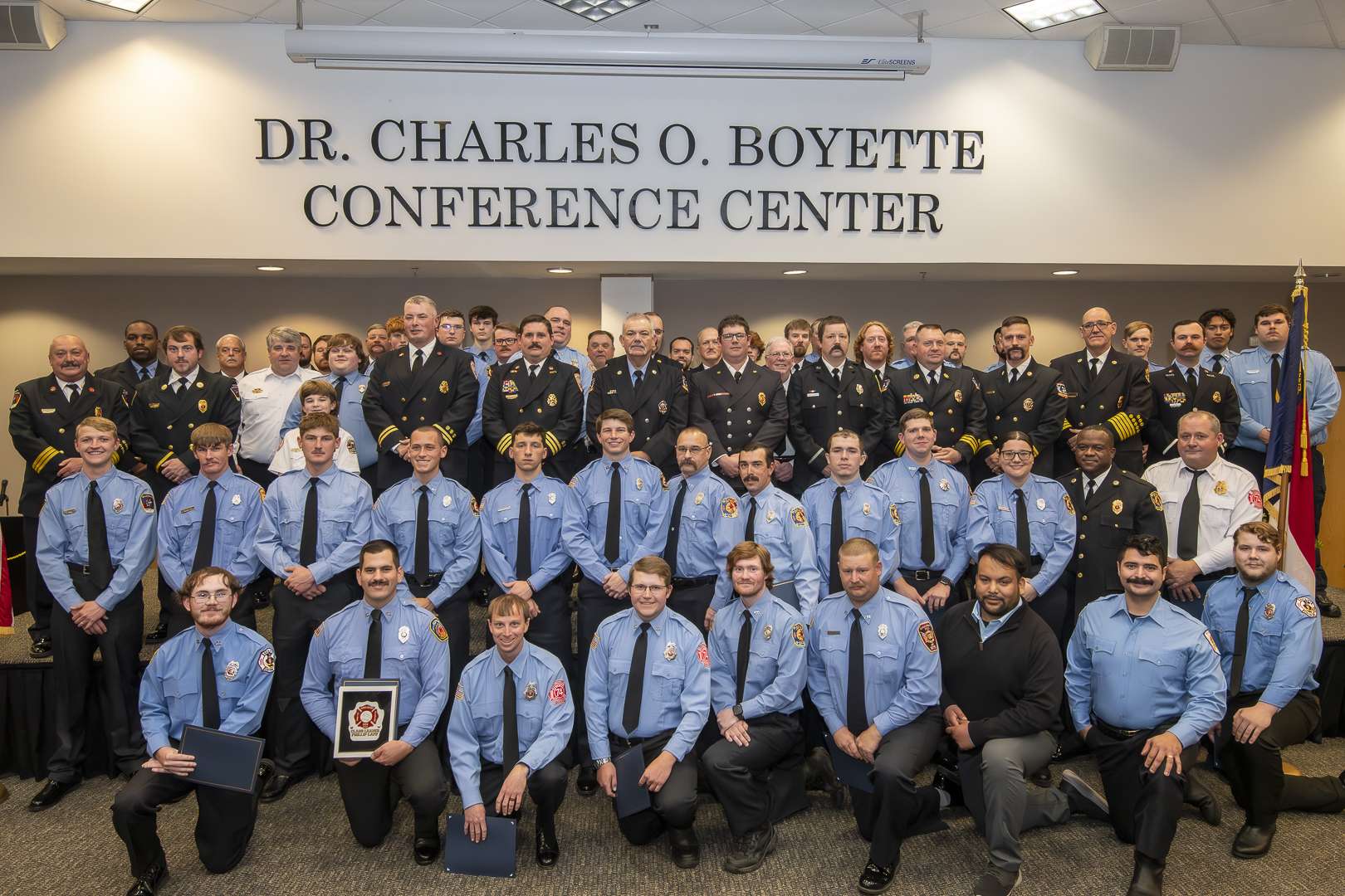 very large group of firefighters in dress uniform