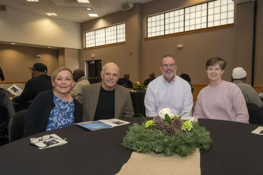 four people at a meeting