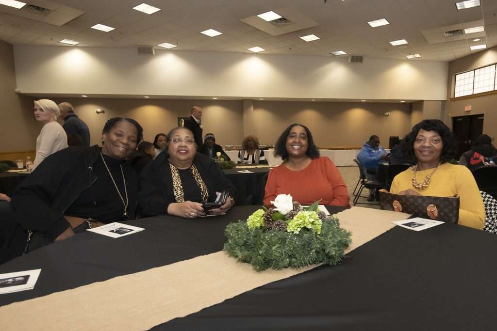 four people in a large room