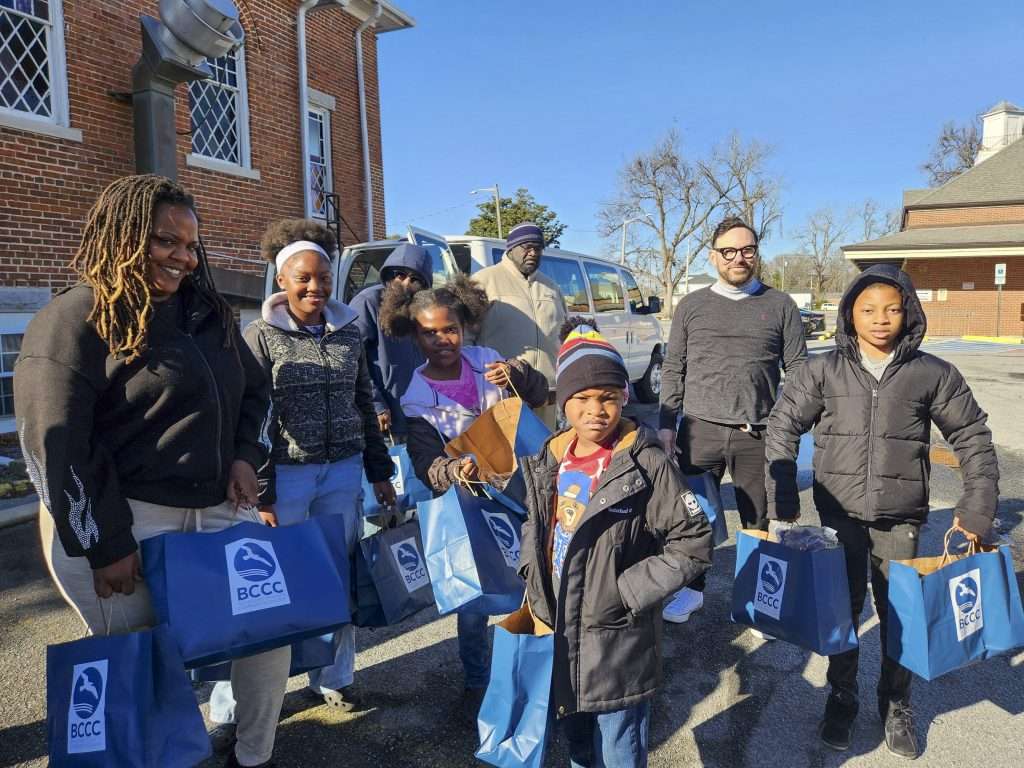 group of people with blue bags