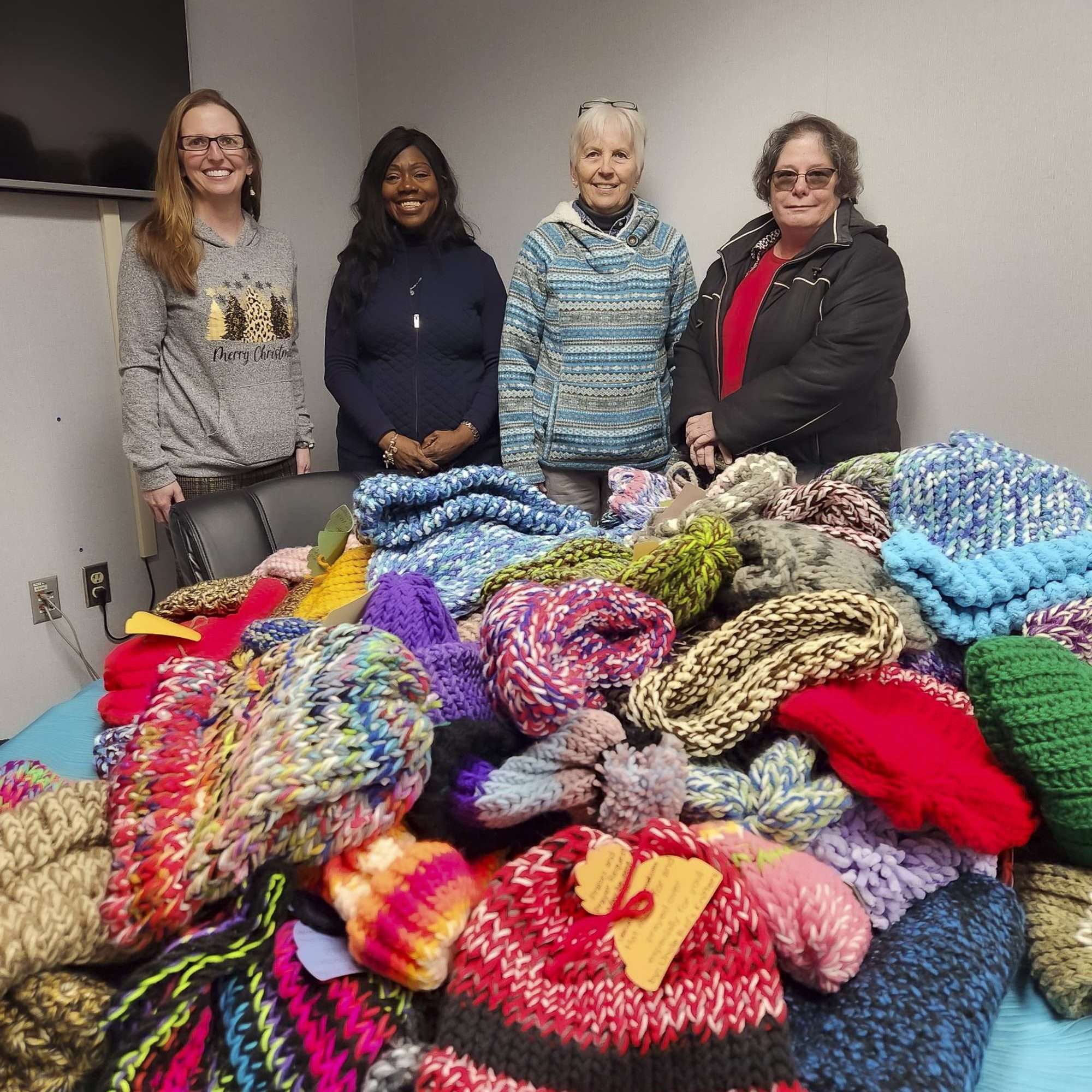 group of people with a pile of hats