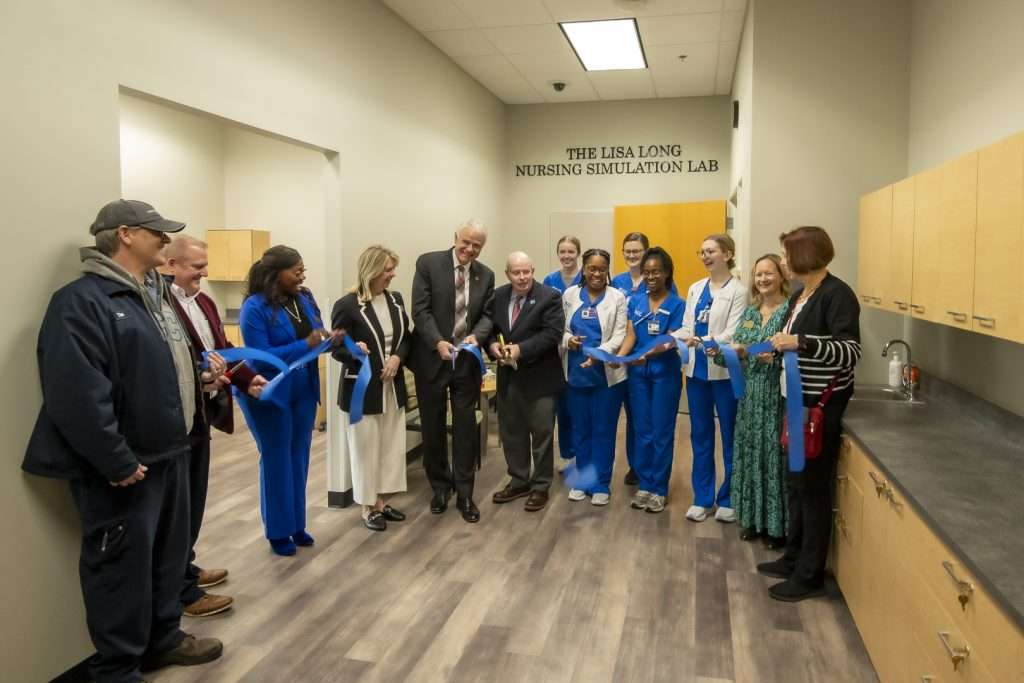 group of people cutting a ribbon