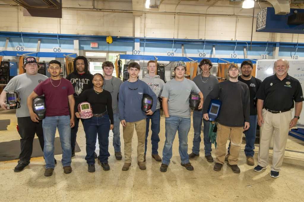 group of people with welding helmets