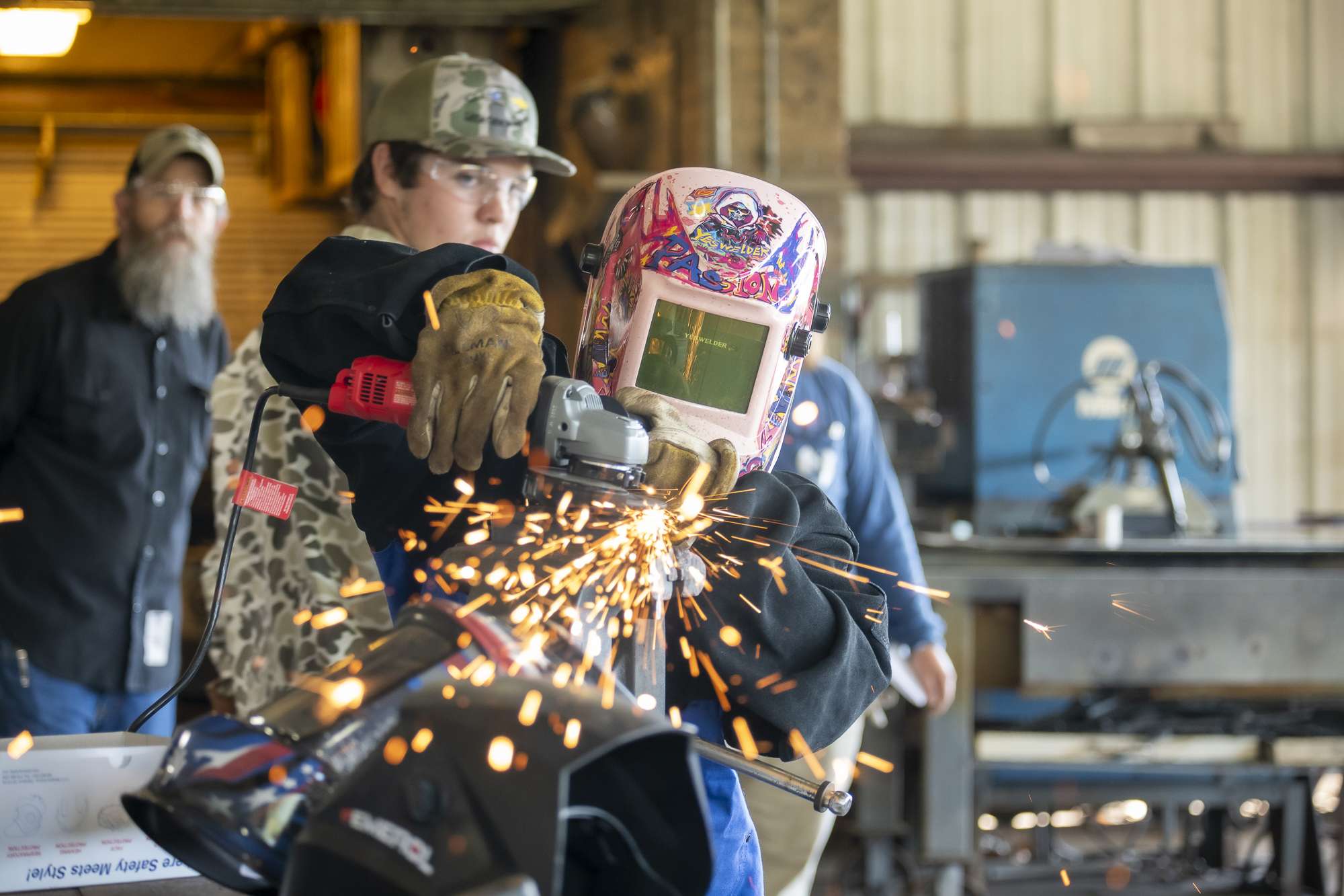 person grinding metal with sparks